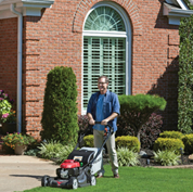 A man with a lawn mowers in front of your house